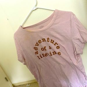 Pink t-shirt with adventure of a lifetime on the front